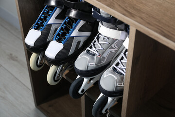 Pairs of roller skates in shelving unit, closeup