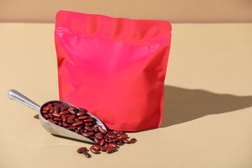 Zipper stand-up pouch and dry kidney beans on beige background, mockup for design