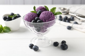 Tasty sorbet with blueberries and mint in dessert bowl on white wooden table, closeup