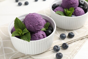 Tasty sorbet with blueberries and mint in bowls on white table, closeup