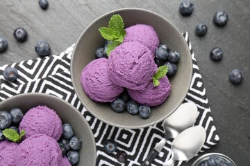 Tasty sorbet with blueberries and mint on black table, flat lay