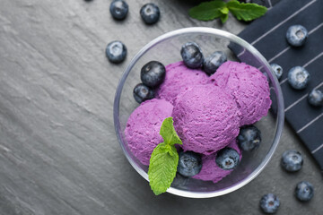 Tasty sorbet with blueberries and mint on black table, flat lay. Space for text