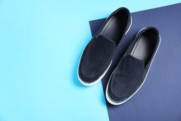 Pair of dark blue shoes on color background, flat lay. Space for text
