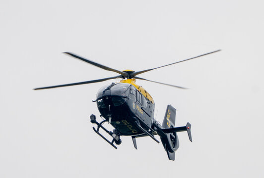 British Police helicopter on a search operation, operated by NPAS for Greater Manchester Police
