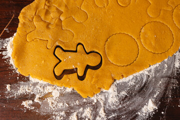 Gingerbread cookie dough with cutter on floured surface, Christmas preparation