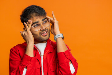 Displeased exhausted Indian Hindu man guy rubbing temples to cure headache problem, suffering from...