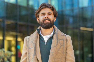 Portrait of smiling Indian Arabian man looking at camera, resting, relaxation feel satisfied glad...