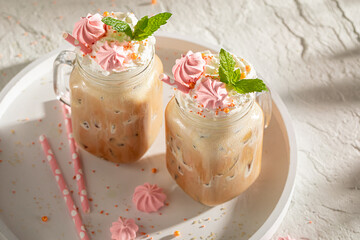 Cold and tasty ice coffee with sprinkles and whipped cream.