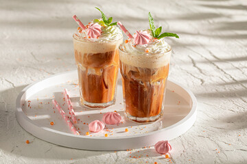 Homemade and fresh ice coffee served in glass with straw.
