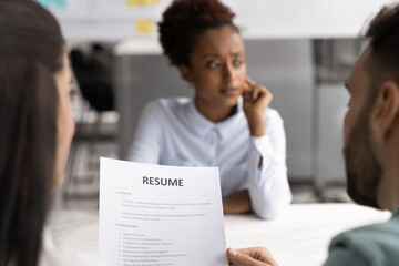 African woman applicant sit at desk feels concerned of frustrated during job interview meeting with...
