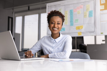 Portrait of smiling African businesswoman, project manager, business analyst or marketing...