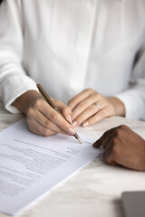 Client puts signature on contract, agreeing to terms for financial advisory services, approving...