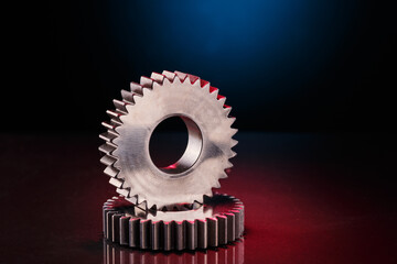 Gears rest on a reflective dark surface