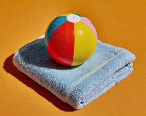 Colorful Glitter Beach Ball on Blue Towel