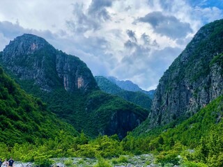 Fototapeta premium Narrow Gorge With Towering Cliffs and Cloudy Sky