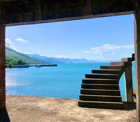 Staircase With View Over Clear Blue Lake and Mountains