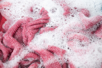 Pink Cashmere Sweater Being Soaked in Soapy Water