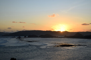 A beautiful sunset on a beach at sea, seen from Merese Hill, Lombok, Indonesia.