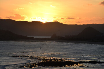 A beautiful sunset on a beach at sea, seen from Merese Hill, Lombok, Indonesia.