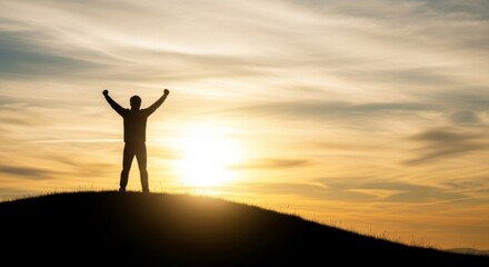 A silhouette of a man with arms raised in triumph stands on a hill against a vibrant sunrise sky