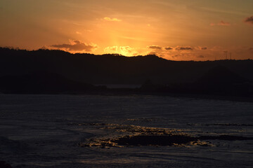 A beautiful sunset on a beach at sea, seen from Merese Hill, Lombok, Indonesia.