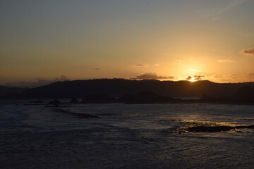 A beautiful sunset on a beach at sea, seen from Merese Hill, Lombok, Indonesia.