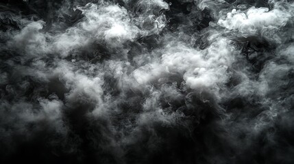 Obraz premium Gray and white smoke swirling against a dark background.