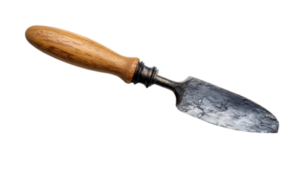 Isolated trowel with a wooden handle and a metal blade against a black background in a studio shot