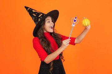 All Hallows witch girl. Girl in witch costume hold magic wand. Happy Halloween. Girl witch in...
