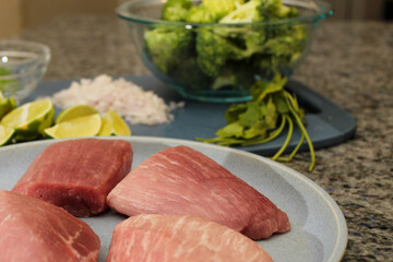Raw Pork Filets and Fresh Produce Prepared for Cooking