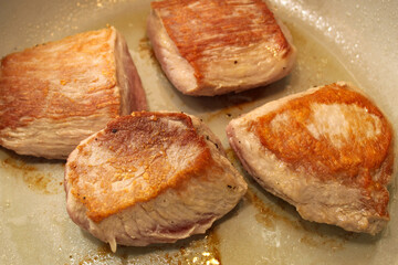Pork Filets Searing in a Pan with Oil