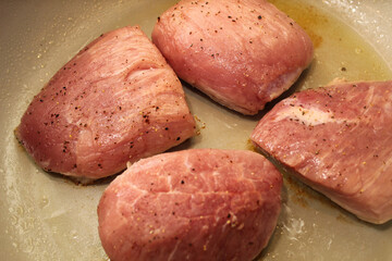 Pork Filets Searing in a Pan with Oil