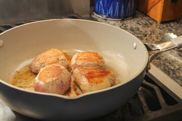 Pork Filets Searing in a Pan with Oil
