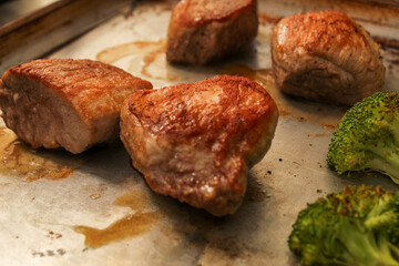 Seared Pork Filets and Broccoli on a Baking Sheet
