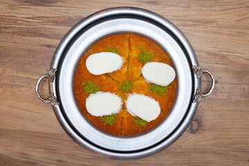 Traditional kunefe dessert with melted cheese and syrup – Turkish sweet pastry kunefe close-up