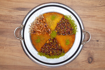 Traditional kunefe dessert with melted cheese and syrup – Turkish sweet pastry kunefe close-up