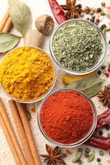 Different aromatic spices on color textured table, flat lay