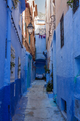 Fototapeta premium Blue Painted Alleyway with Mountain View in Chefchaouen Morocco
