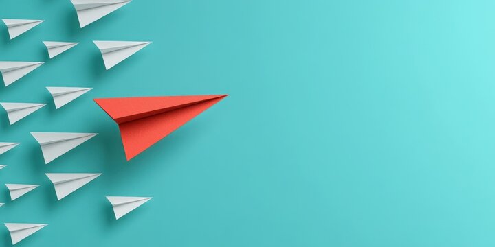 A red paper airplane flying ahead and leading a group of white paper airplanes against a turquoise background representing leadership and uniqueness