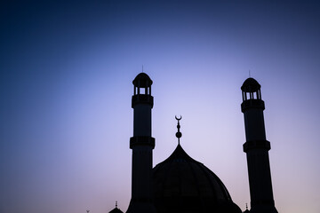 Grand mosque with golden domes and tall minarets.