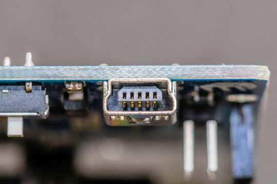 Close-up of a USB port on a circuit board, showcasing pins and technology components