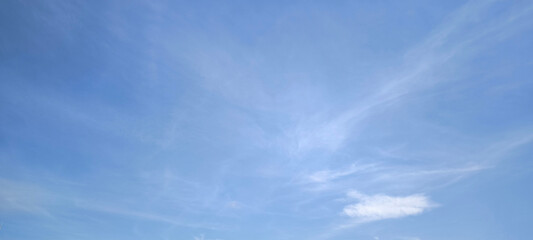 Background with clouds on blue sky. Sky view. Beautiful sunny sky. Clouds on blue sky. Sun shining through the puffy clouds.