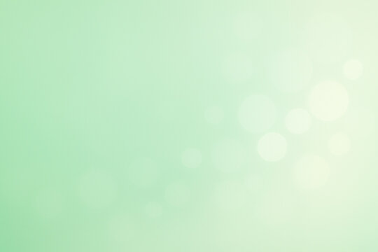 Soft mint green gradient background with subtle bokeh lights