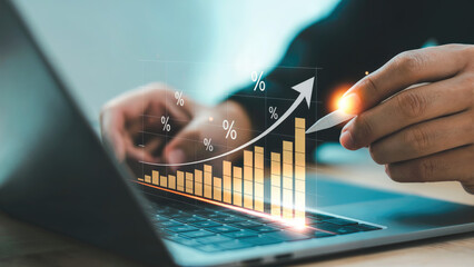 Financial growth chart displayed on laptop with upward arrow