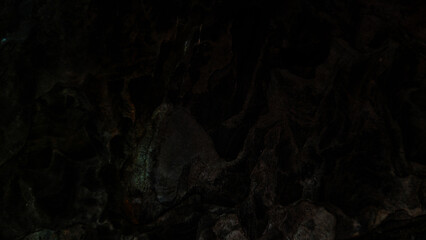 Dark rough stone wall background in vintage style for graphic design or wallpaper.