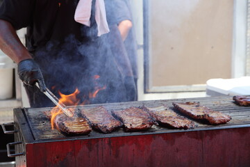 Lively summer scenes from a ribfest celebration featuring sizzling barbecue, smoked meats, and food vendor culture. A feast of flavor, fire, and community under warm seasonal skies in Columbus, Ohio.