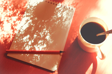 Cup of coffee, notepad, pencil on paper, sketchbook,  background with casting shadows . Inspiration and New story concept