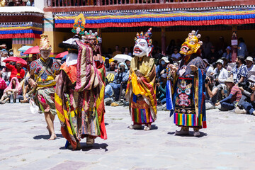 Masked dancers in elaborate costumes perform sacred Cham rituals during the Hemis Festival in Ladakh. This vibrant celebration reflects Tibetan Buddhist culture, mythology, and spiritual heritage.