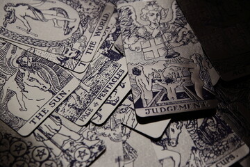 Mystical atmosphere captured through a detailed tarot card arrangement on a textured surface. Rich symbolism and traditional esoteric themes evoke intuition, divination, and spiritual insight. Ideal f