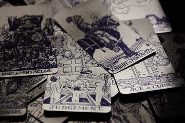 Mystical atmosphere captured through a detailed tarot card arrangement on a textured surface. Rich symbolism and traditional esoteric themes evoke intuition, divination, and spiritual insight. Ideal f